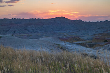 Wheat Grass And Mountains At Sunset In Badlands National Park