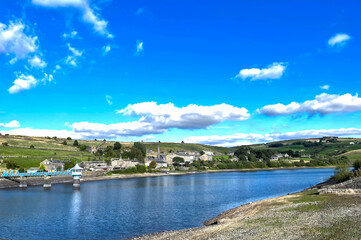 View across, Leeming Reservoir, on a summers day, with old cottages in the distance in, Leeming, Keighley, UK