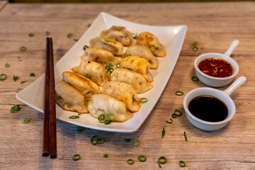 Fried beef dumplings, traditional Chinese dish with soy and chili sauce on the side