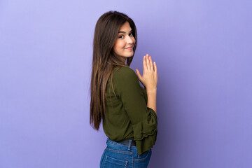 Teenager Brazilian girl over isolated purple background scheming something