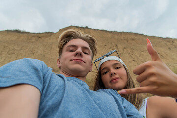 Group of cute teenage friends taking a selfie - Tourists taking a photograph on a day trip. happy...