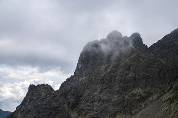 Scenic view of cloudy rainy rocky High Tatras mountains covered in fog. Natural landscape in Slovakia
