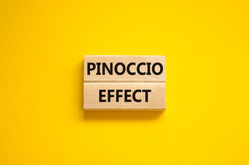 Pinoccio effect symbol. Concept words Pinoccio effect on wooden blocks on a beautiful yellow...