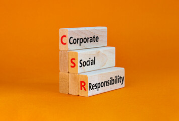 Corporate social responsibility symbol. Concept words CSR, corporate social responsibility on blocks on a beautiful orange background. Business, corporate social responsibility concept. Copy space.