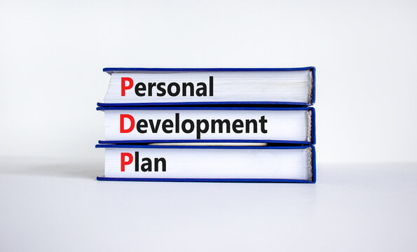 PDP, Personal development plan symbol. Words PDP, Personal development plan symbol on books on a beautiful white background. Business, PDP, Personal development plan symbol concept. Copy space.