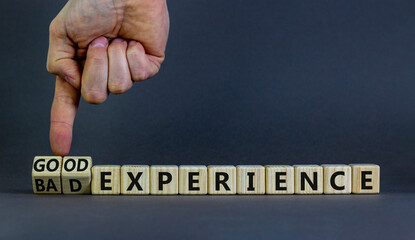 Good or bad experience symbol. Businessman turns wooden cubes, changes words bad experience to good experience. Beautiful grey background, copy space. Business, good or bad experience concept.