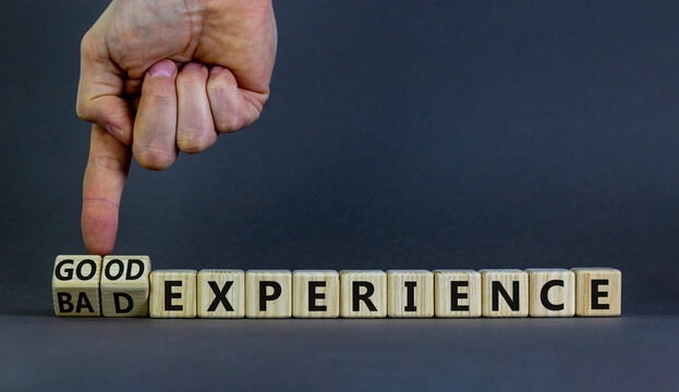 Good or bad experience symbol. Businessman turns wooden cubes, changes words bad experience to good experience. Beautiful grey background, copy space. Business, good or bad experience concept.
