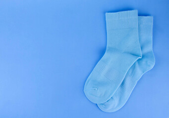 Blue socks on a blue background. Socks on a colored background