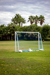 miniature football game goal on green grass.