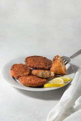 Ready fried fish cakes from caviar. Bright orange on a white background.