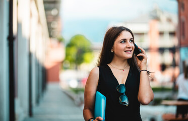 Student walks talking on the phone incity.