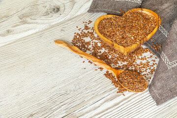 Flax seeds in wooden bowl. Close up.