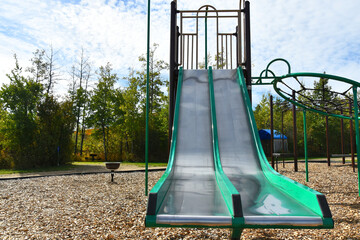 An image of a brightly colored slide on a children's playground. 