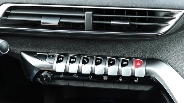 The panel of various buttons made of aluminum in a modern car. Air deflectors, sos and navi panel button