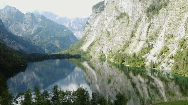 Flight over the beautiful Lake Obersee in Berchtesgaden National Park, Germany. Wonderful 4k aerial drone view of Bavarian Alps.
