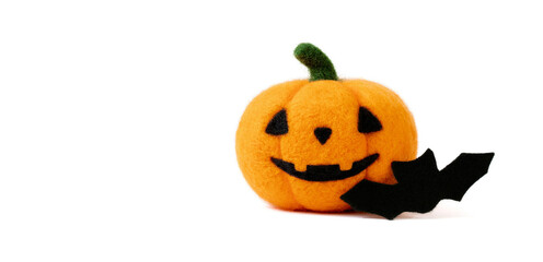 Halloween pumpkin isolated on a white background. Wool Jack o lantern pumpkin head and bat. Felting toy. Banner. Space for text.