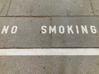 No Smoking inscription on asphalt