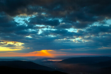 bright sunrise in the mountains with blue sky