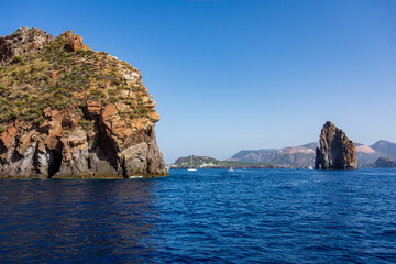 Fototapeta premium Lipari island (Aeolian archipelago), Messina, Sicily, Italy: view of the stack rocks with the island of Vulcano in the background.