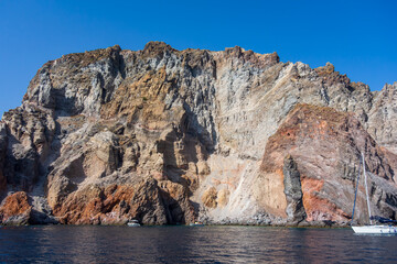 Fototapeta na wymiar Lipari island (Aeolian archipelago), Messina, Sicily, Italy: view of the seacoast with red rocks.
