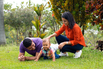 Dad and mom with their son in the field.