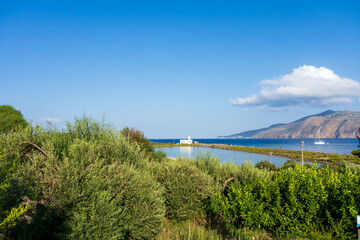 Salina island (Aeolian archipelago), Messina, Sicily, Italy, 08.17.2021: view of the salt lake with the white lighthouse in the background in Punta Lingua.
