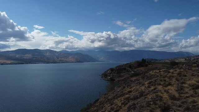 Video from drone lowering down toward shores of Lake Chelan,  Washington on a beautiful fall day.