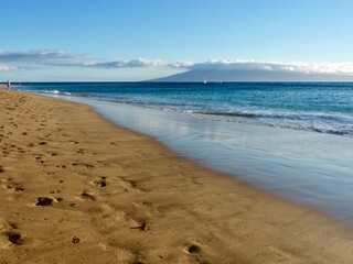 footprints on the sand in Queens Beach, Honolulu Hawaii 