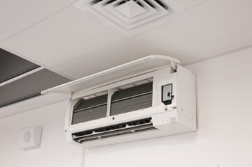 the employee performs service and cleaning of the air conditioner indoor unit