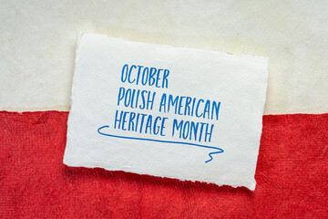 October - Polish American Heritage Month, handwritten note against a paper abstract in colors of Poland  national flag - white and red, reminder of celebration and cultural event