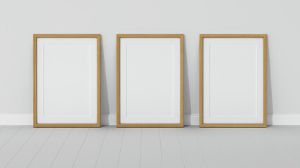 Three wooden frames on wooden floor with a white wall. Empty interior. 3D render vertical wooden frame mock up. White parquet. 3D illustrations. 3D design interior. Triptych. Passe partout frame.