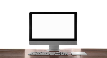 Modern computer with blank monitor screen and peripherals on wooden table against white background