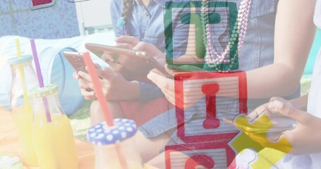 Animation of colourful puzzle pieces and autism text over children using smartphone and tablet - Powered by Adobe