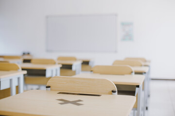 Empty Classroom without student with desks, chairs and whiteboard during pandemic