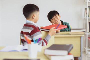 Fototapeta na wymiar Happy Asian schoolboy interacted in the classroom