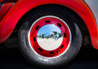 Close up of a car wheel with chrome hubcap