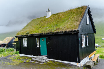 Close up view of the beautiful Black house with grass on the roof in the Faroe Islands 