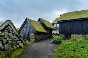 Fototapeta na wymiar Close up view of the beautiful Black house with grass on the roof in the Faroe Islands 