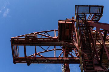 Fototapeta na wymiar View looking up through industrial structures with stairs and walkways, horizontal aspect