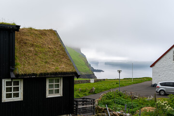 Fototapeta premium Close up view of the beautiful Black house with grass on the roof in the Faroe Islands 