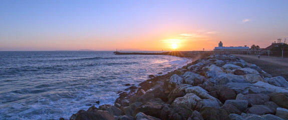 Sunset at Port Hueneme beach jetty rock seawall in Oxnard California United States