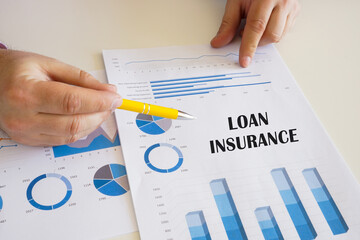 Business concept about LOAN INSURANCE with sign on the chart sheet.