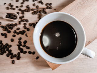 coffee​ cup​ and​ seed​ coffee​ on​ wooden​