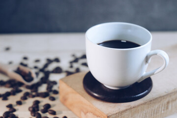 coffee​ cup​ and​ seed​ coffee​ on​ wooden​