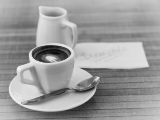 cup of coffee with good morning written in a card
