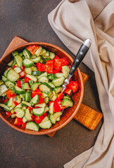 Mixed salad of cucumbers, tomatoes in a bowl.