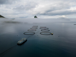 Beautiful aerial view of the Salmon fishing farm pools and boat
 in the Faroe islands 
