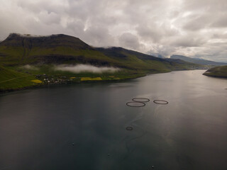 Beautiful aerial view of the Salmon fishing farm pools and boat
 in the Faroe islands 