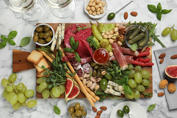 Set of different delicious appetizers served on white marble table, flat lay