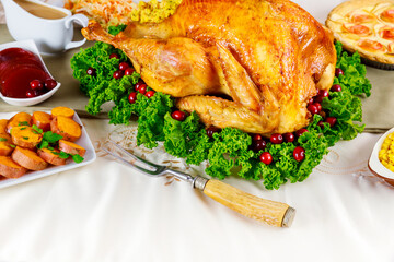 Served table for Thanksgiving dinner with roasted turkey.